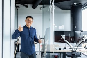 Man with black air with a thumbs up